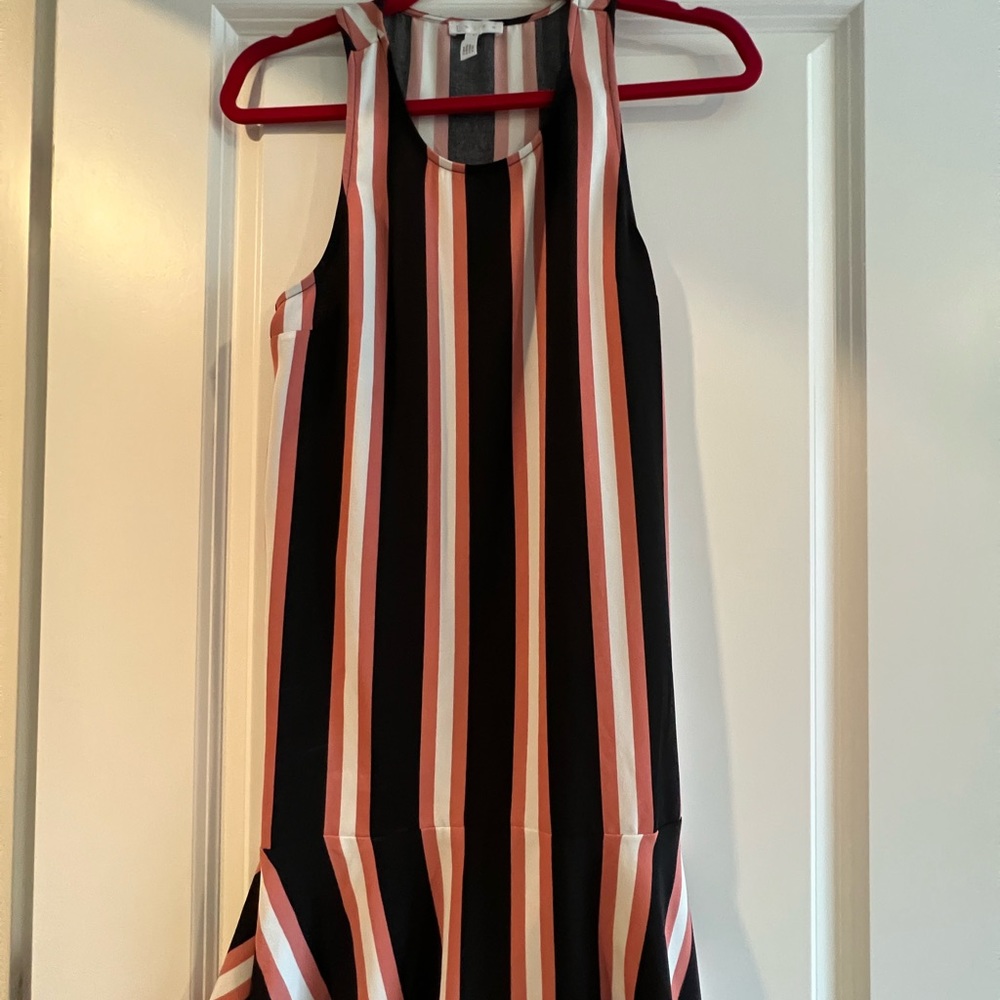 Racerback striped dress. Flouncy bottom hem detail.